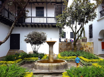 Colonial courtyard with a fountain and gardens in the historic center of Bogotá