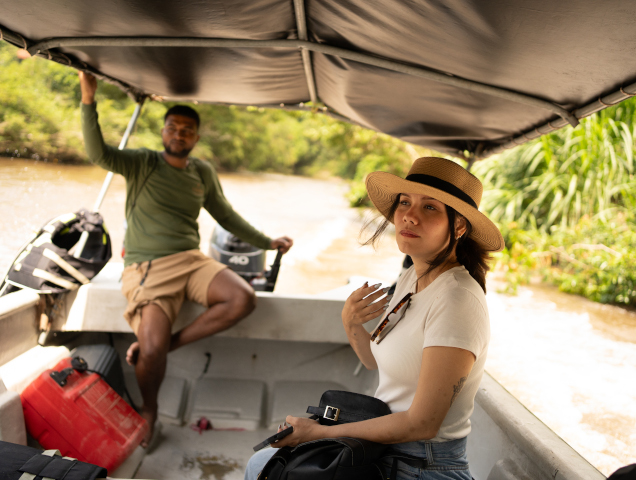 Tourists traveling along a river surrounded by vegetation in the Sierra Nevada