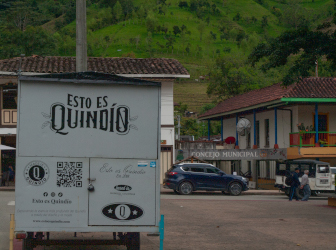 Street in a coffee town in Quindío with traditional architecture and a mountainous landscape