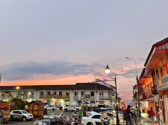 Colombian coffee town at sunset with traditional architecture and busy streets